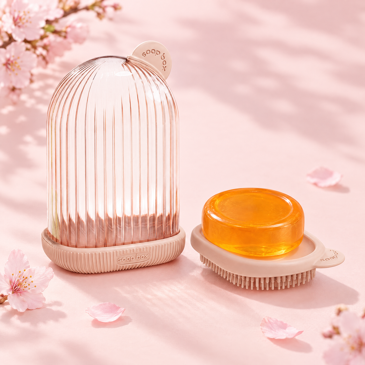Pink ribbed travel soap case with an amber soap bar on its tray